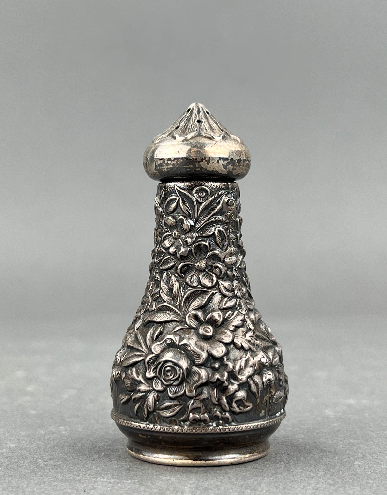 Antique S. Kirk & Son Sterling Silver Repusse Salt Shaker: Intricately smithed salt shaker by S. Kirk & Sons with a floral motif. Measures 1 3/4" D x 3 1/4" H Weight 1.8 ounces