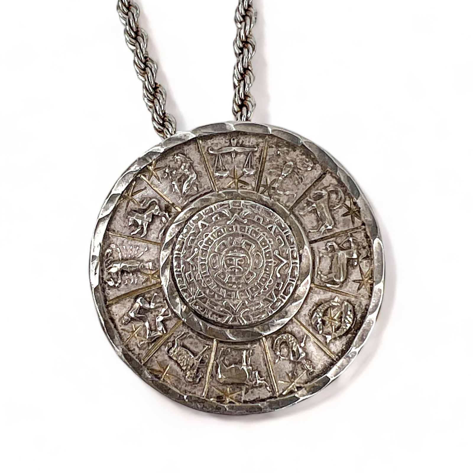 Vintage Mexican Sterling Silver Zodiac Pendant or Brooch: Sterling Silver, Vintage Zodiac Pendant with option to wear as brooch, handmade in Mexico and stamped. Vintage rope chain by Monet. Measures: Pendant/Brooch 1 1/2" Dia x 1/4" H Chain Length 16 1/2" an