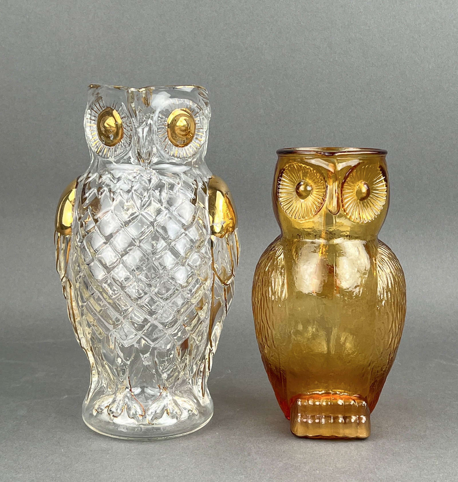 Vintage and Antique Owl Pitchers: Mid Century Amber glass owl pitcher and an antique Art Nouveau gold leaf owl pitcher, late 1800's (Note.. see photos for some missing gold leaf Measures Clear Pitcher 5 1/2" W x 6" D x 10" H Brown Pit