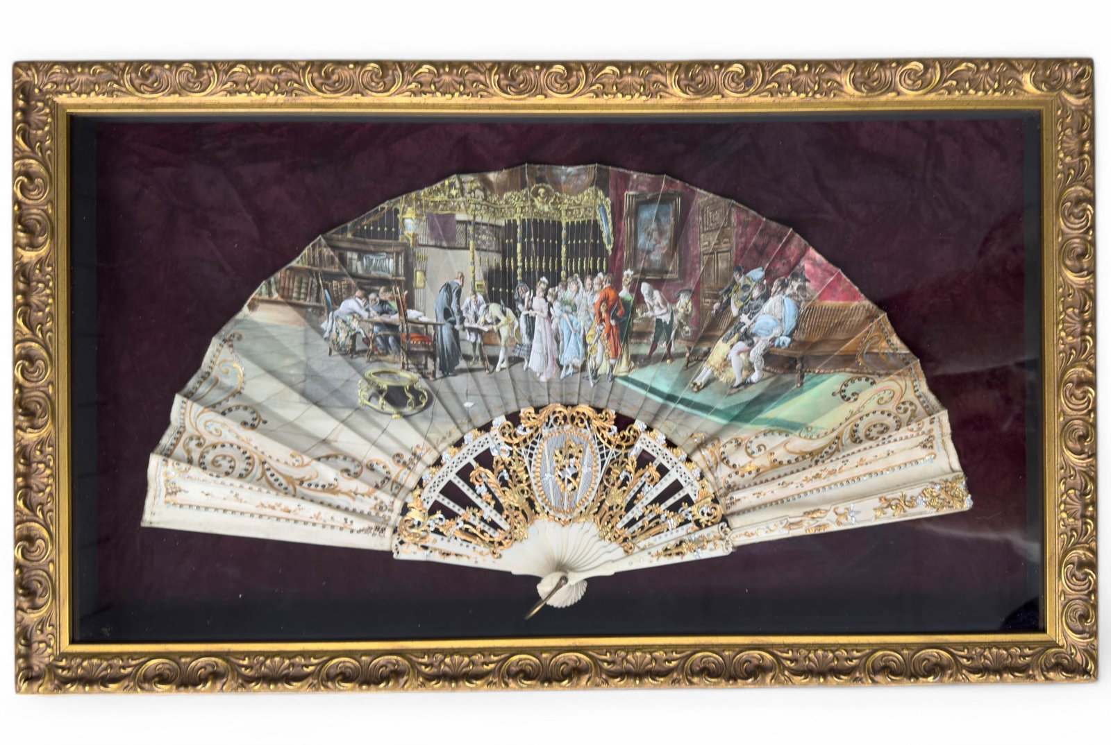 Antique Spanish Hand Painted Fan in Gilt Framed Shadowbox: Antique Spanish Fan, depicting a court scene hand painted on silk or satin with meticuously sewn on paillettes over a carved bone frame with gilt and silver gilt detailing. Fan Frame Measures 21 3/4" 