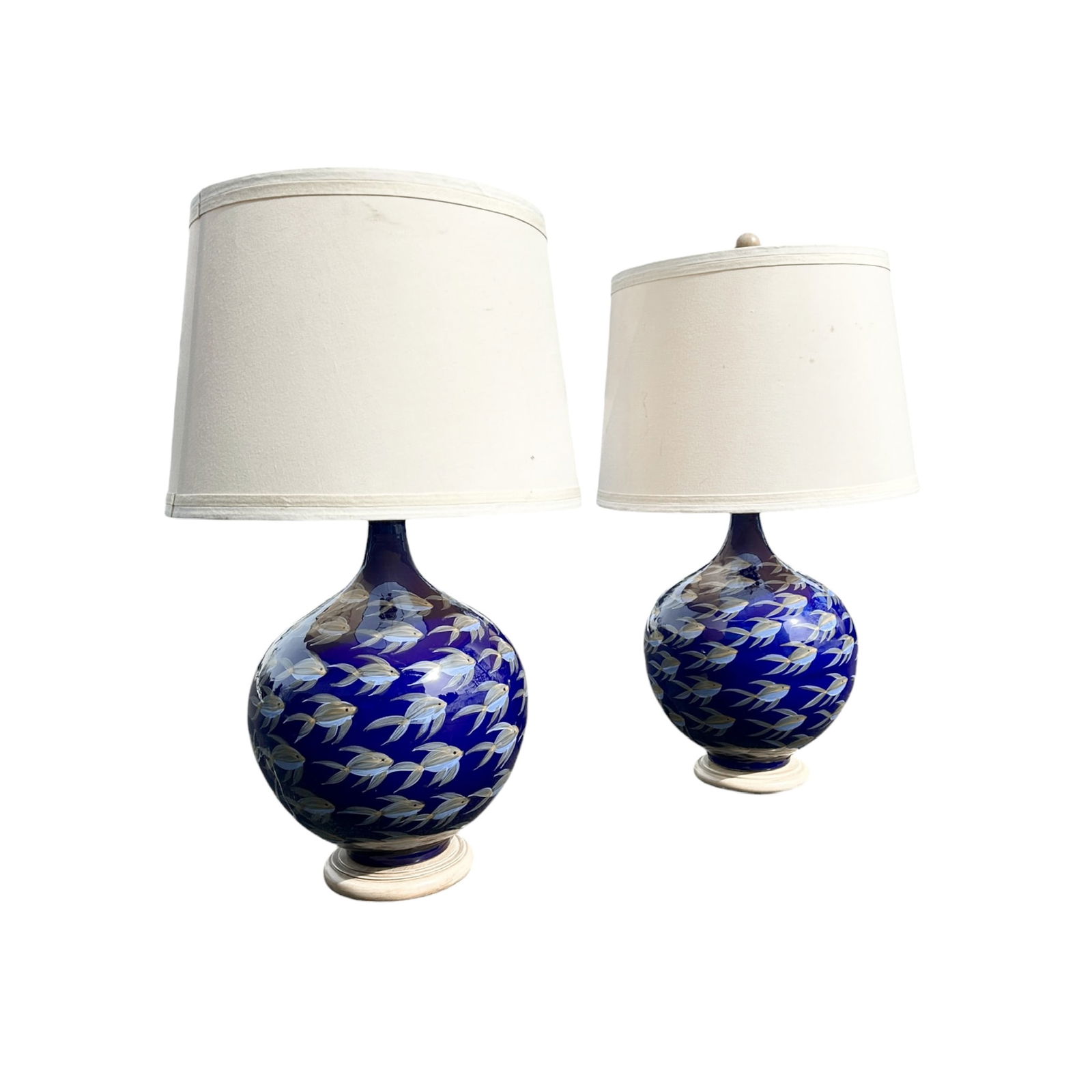 Pair, Vintage Blue Ceramic Sphere Fish Table Lamps: Phenomenal pair of blue ceramic fish lamps in blue with white and yellow accents. Chrome hardware with dimmer switches. Wooden base and finial in white finish, topped by a fabric drum shade with