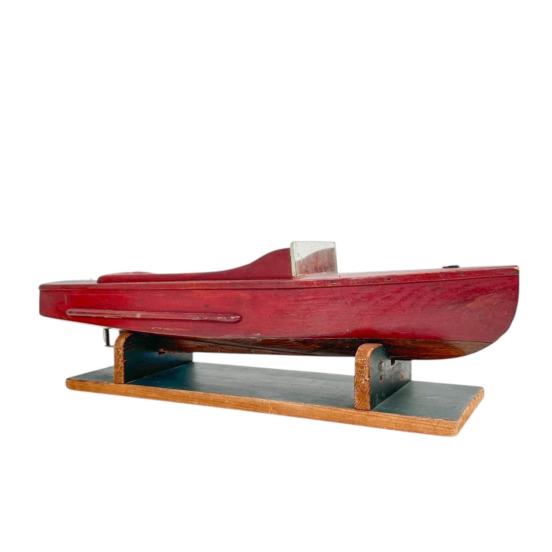 Vintage Wooden Speed Boat Model Ship: Vintage 1920's or 30's speed boat model boat, hand carved of solid wood and painted red with glass windshield. Set upon staned painted dark green. Measures 19" w x 5" D x 6" H