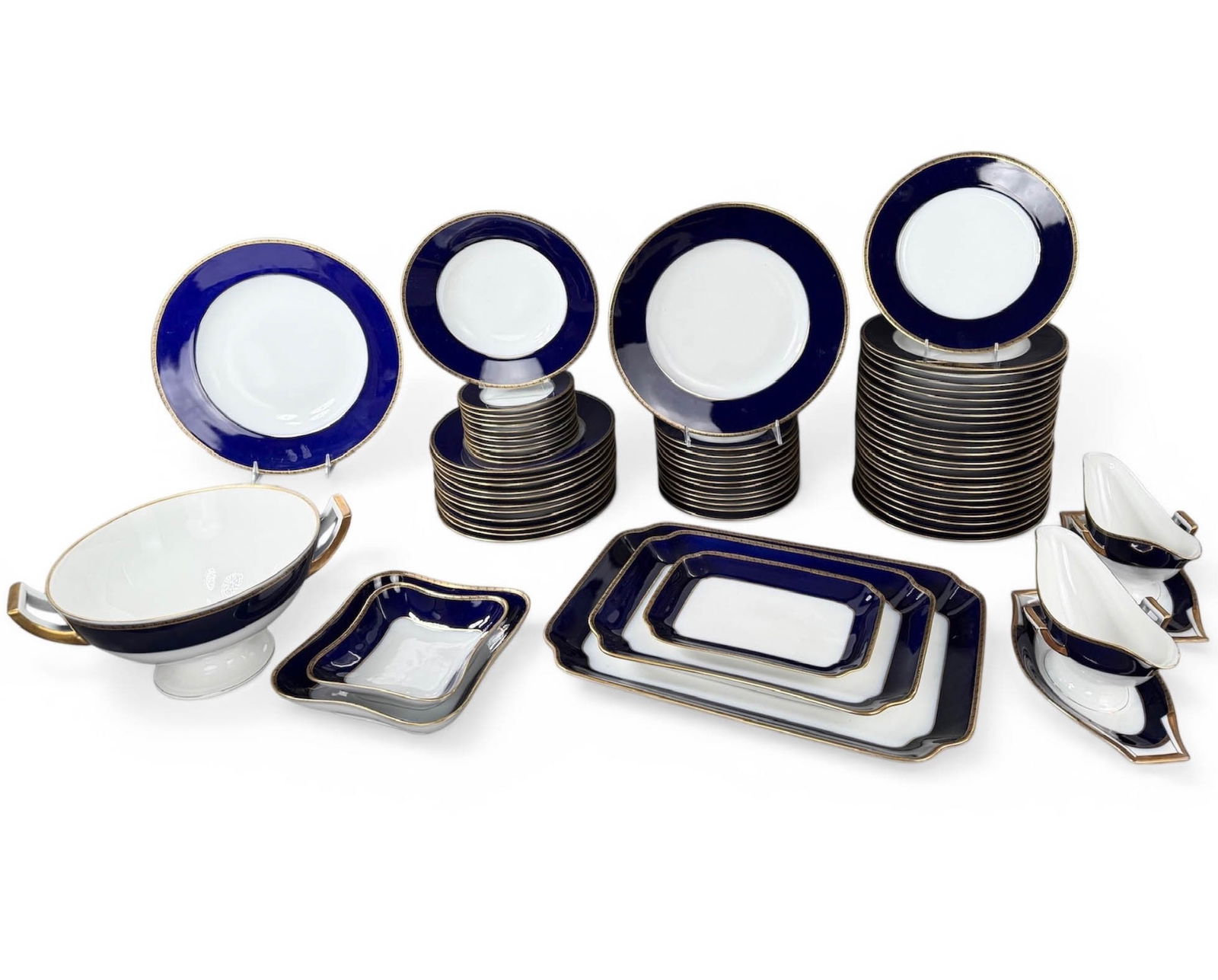 Huschenreuther Hohenberg Bavaria China Set in Cobalt (76) pcs: (76) Piece set of fine Antique German porcelain tableware with colbalt blue and gold trim.