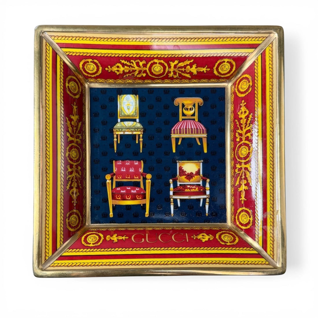 Gucci Porcellana Trinket Tray: Gucci Porcellana, porcelain square trinket tray with 18th century Louis XVI chair motif in red, gold, yellow and blue. Measures 7 3/8" x 7 3/*"