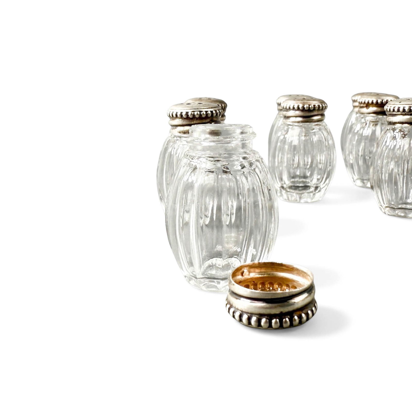(11) Cristofle Silver and Glass Salt and Pepper Shakers: Eleven vintage cristofle France siler and glass individual setting sale and pepper shakers. Please refer to the following address for the pick-up location: 2 Quogue Plaza Trail, Quogue, NY 12139