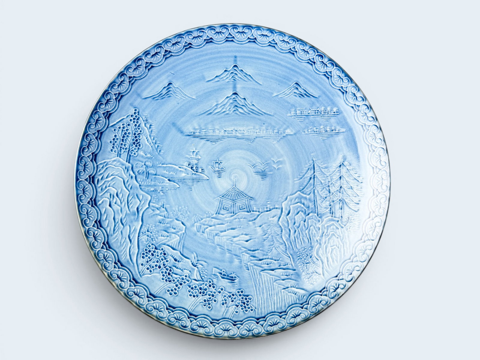 JAPANESE ARITA WARE PORCELAIN PLATE: Japanese Arita Imari ware blue glazed porcelain plate with mountain scene. 9 5/8 X 1 1/2"