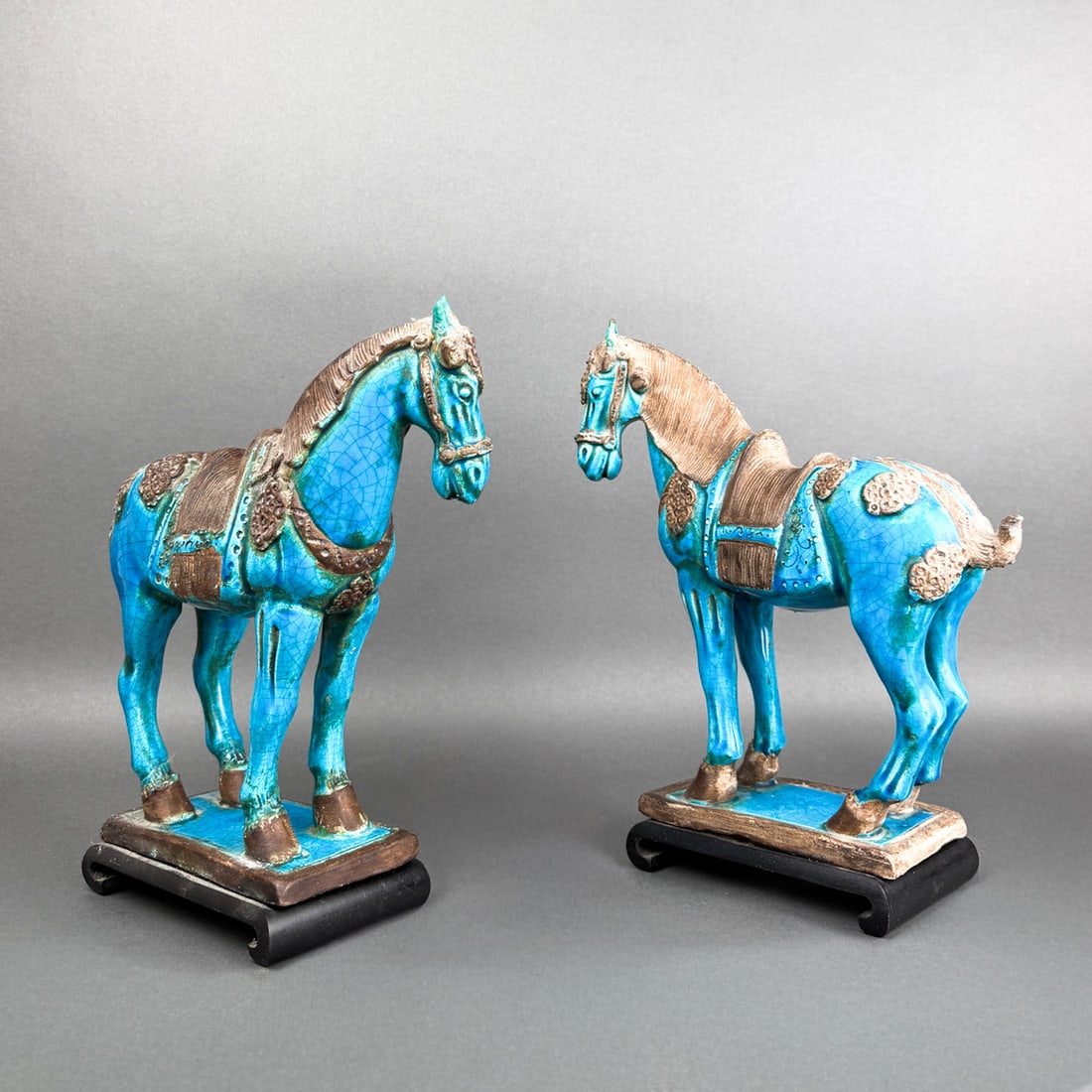 PAIR OF TANG STYLE PORCELAIN HORSES: Nicely made pair of porcelain and turquoise glaze Tang Dynasty horse figurines fixed to rosewood bases. 10 3/4" h x 9 1/2" x 3 1/4"
