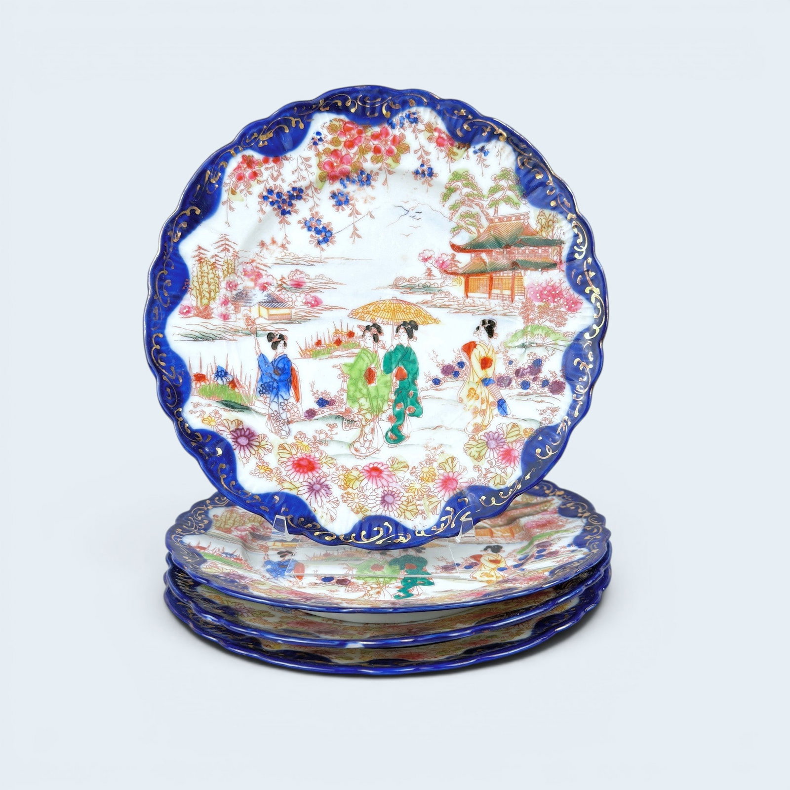 JAPANESE KUTANI PLATES: Antique Japanese porcelain kutani plates with geisha motif and an all over blue and white botanic motif. 8 1/2" dia