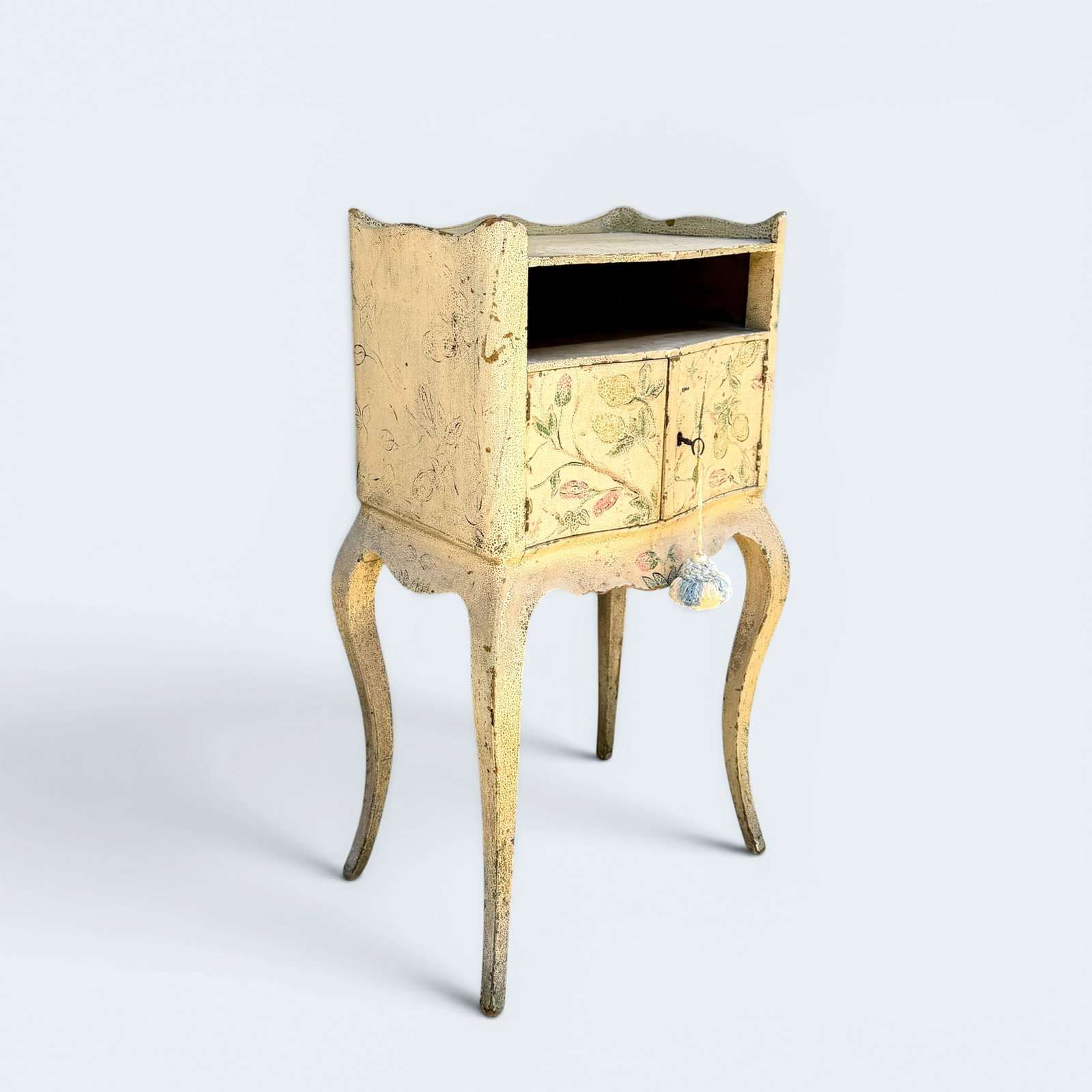ANTIQUE VENETIAN NIGHT STAND: Antique venetian style two door, open self shelf with off-white paint and floral motif. 33 1/4" h, 17 1/4" w, 12" d