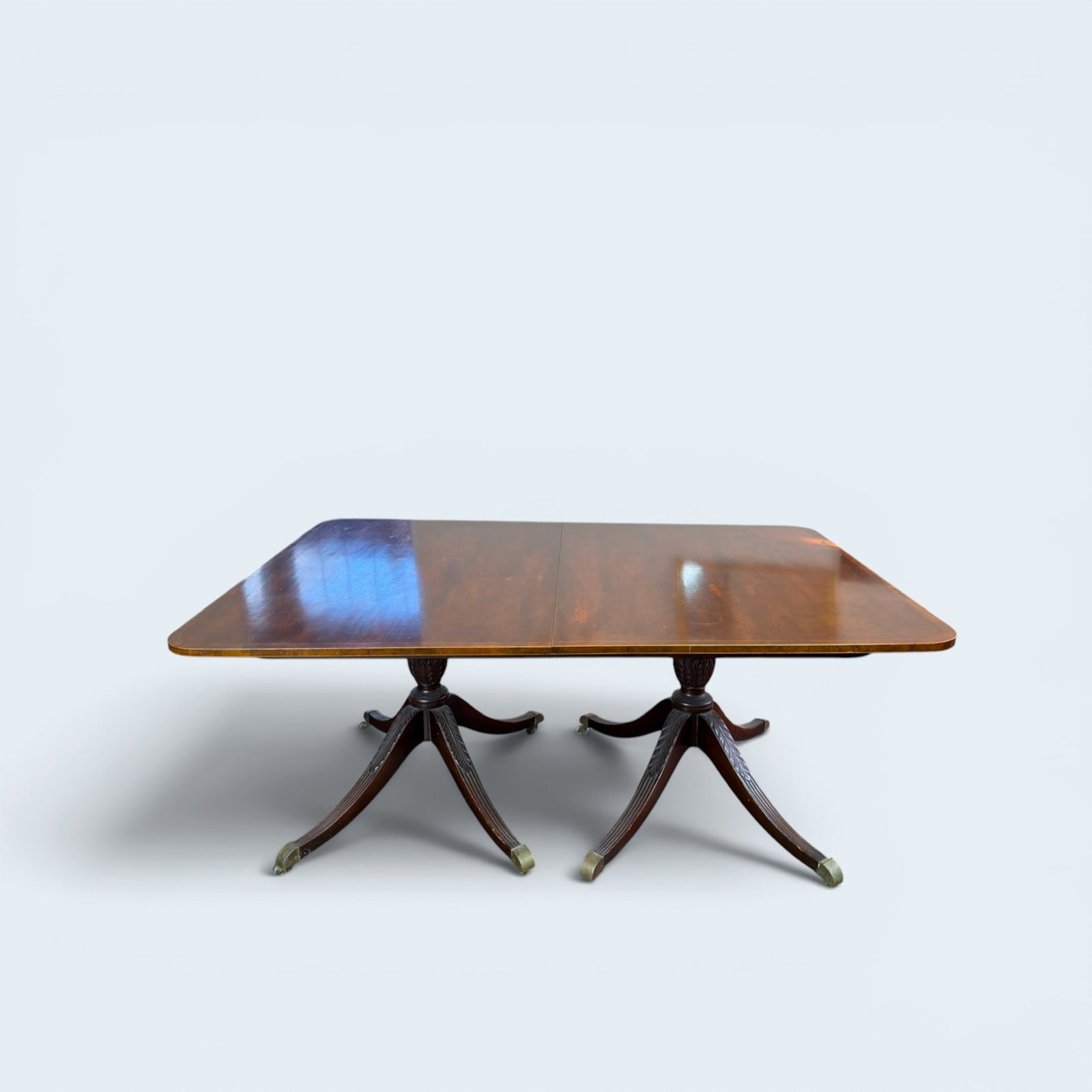REGENCY DOUBLE PEDESTAL BASE MAHOGANY TABLE: with three leaf extensions, original pads and case for pads and extensions