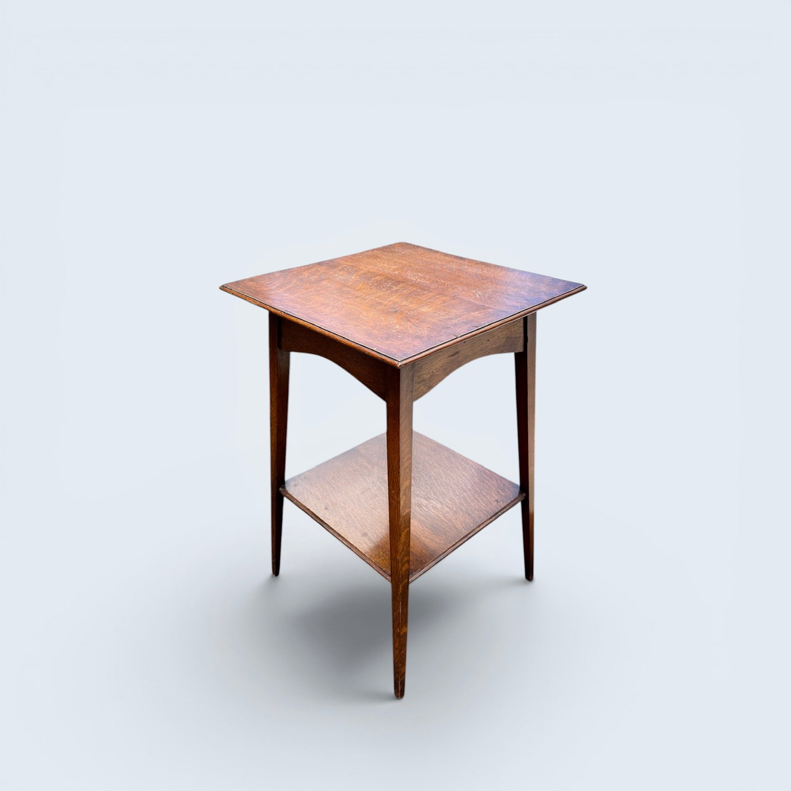 EDWARDIAN OAK SIDE TABLE: Antique victorian oak graduating table top to shelf with tapered leg side table.