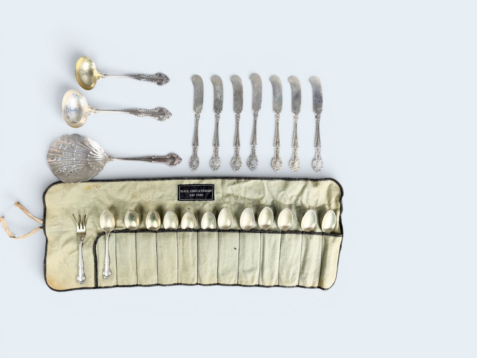 GORHAM ENGLISH GADROON FLATWARE: pie lift has sterling handle. Slatted spoon marked sterling. spoon measures 8 3/4" l Pie lift measures 10" and is marked Sterling. Butter knives measure 5 3/4" in length ozt