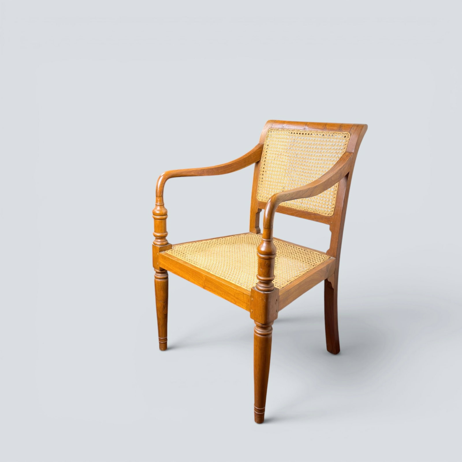 ENGLISH COLONIAL ARM CHAIR: Traditional english colonial turned wood armchair with cane back and seat. 34 1/2" h / 17" seat height, 23 1/2" w x 23" d