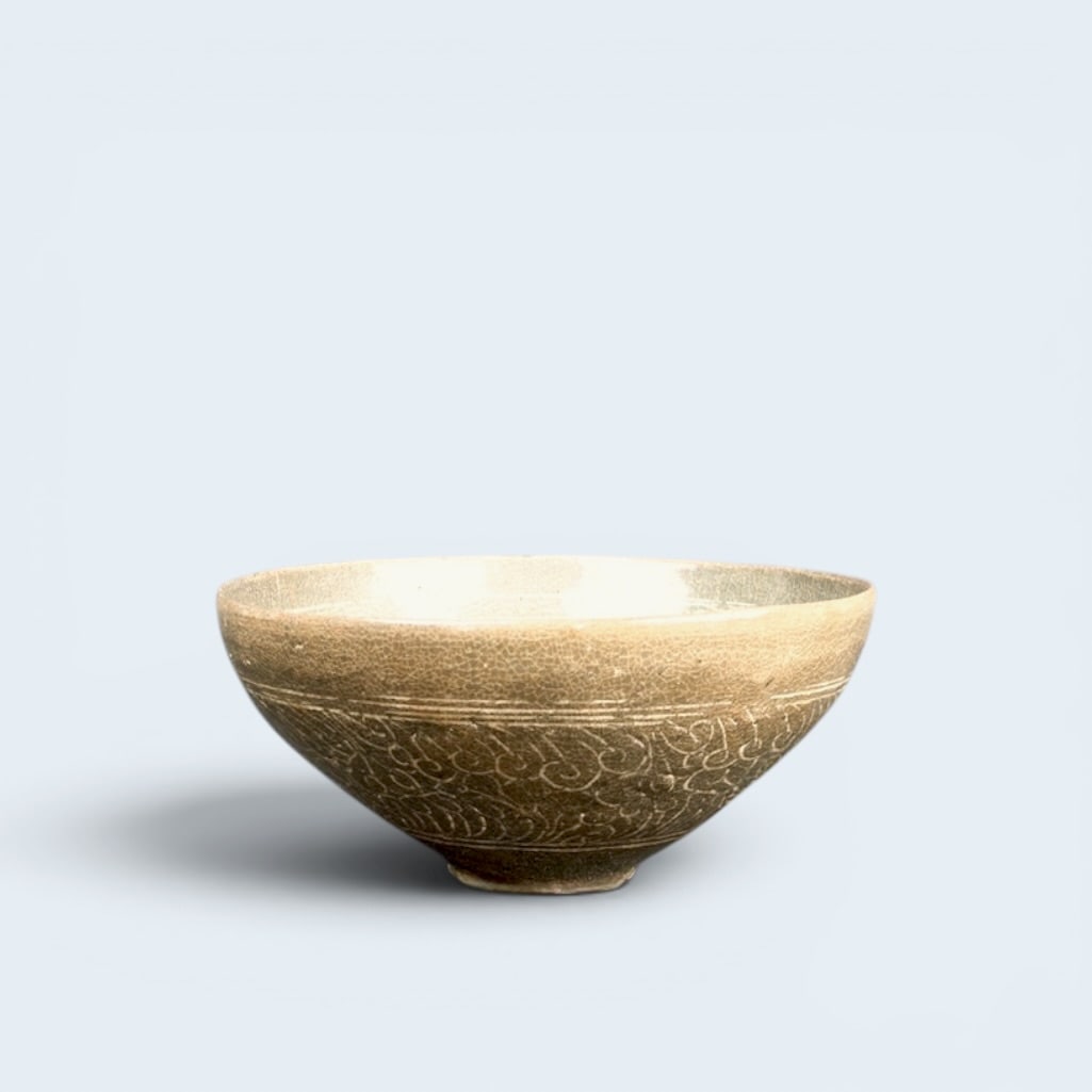 KOREAN GORYEO DYNASTY CELADON TEA BOWL: Antique Goryeo Dynasty (918-1392) ceramic tea bowl with celadon glaze. Exterior swirl in relief and interior fauna and fruit.