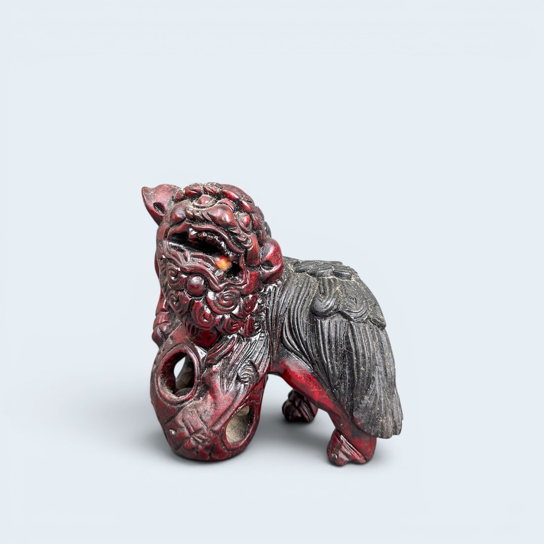 19th c. CHINESE CARVED LACQUERED WOOD FOO DOG: Antique red lacquered wood carved foo dog figure with moving ball in cage and mouth. Artists carved signature on base. 6 1/4" h x 6" w x 4" d