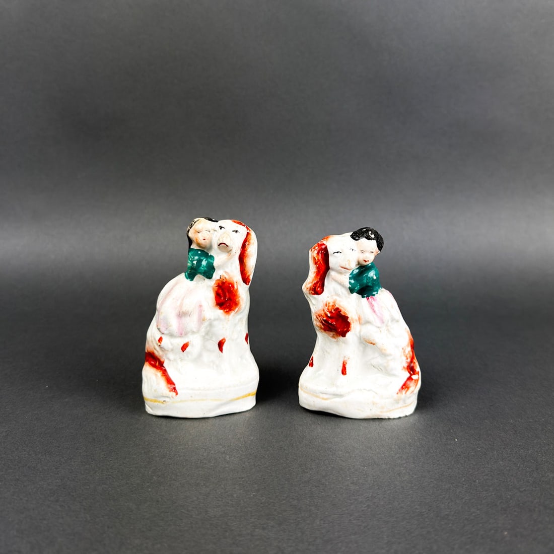 STAFFORDSHIRE LARGE DOG WITH CHILD FIGURINES: English Staffordshire Porcelain dog figurines with children as riders.
