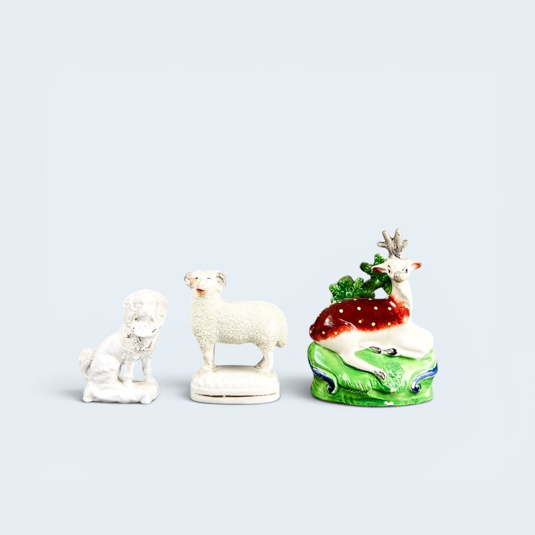(3) STAFFORDSHIRE ANIMAL FIGURINES: Vintage c. 1920's and 30's Deer or fawn, Spaniel with a basket and lamb or sheep figurines.