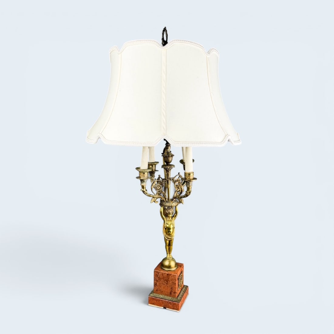 NEOCLASSICAL CANDELABRA TABLE LAMP: Bronze gilt cherub above a red marble base, below four light candelabra electrified.Stands 34" Tall