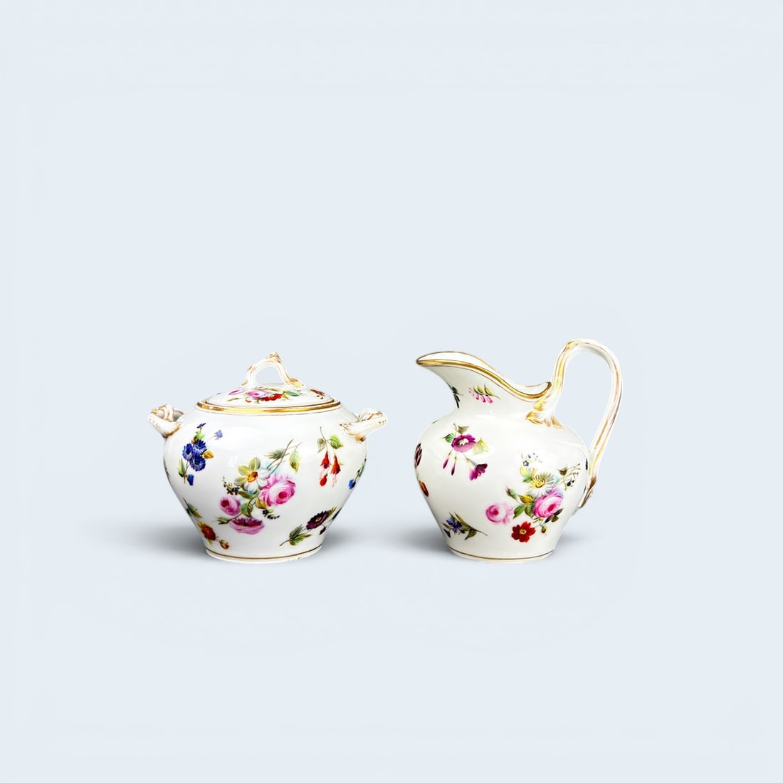 ANTIQUE MEISSEN SCATTERED FLOWERS SUGAR BOWL AND CREAMER: Meissen c. 1880's sugar bowl and creamer in scattered flowers pattern. Intricate details on the handles and lid pertaining to a branch and botanical form. Creamer measures