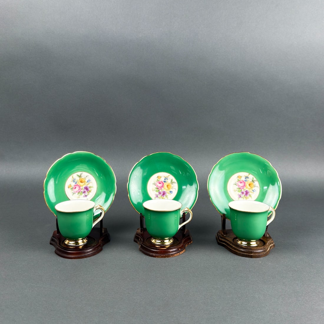 (3) KPM ROYAL GERMANY CUPS AND SAUCER SETS: Three cup and saucer sets of German KPM porcelain with golt handles and nice green glaze bodies.
