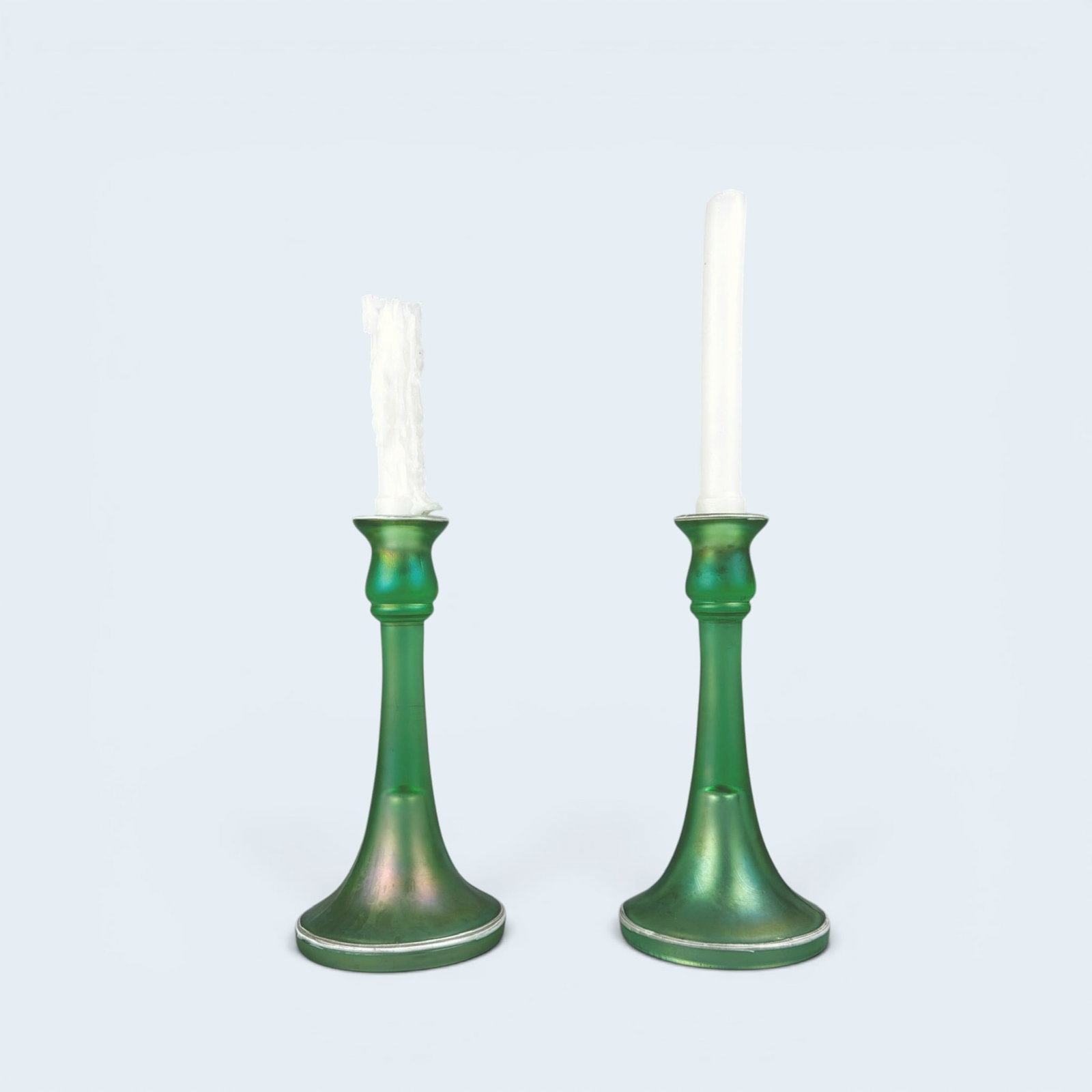 Pair of DUGAN OPALESCENT URANIUM GLASS CANDLESTICKS: Circa 1930's opalescent uranium glass candlesticks. 10 1/8" in height, 4 1/2" diameter