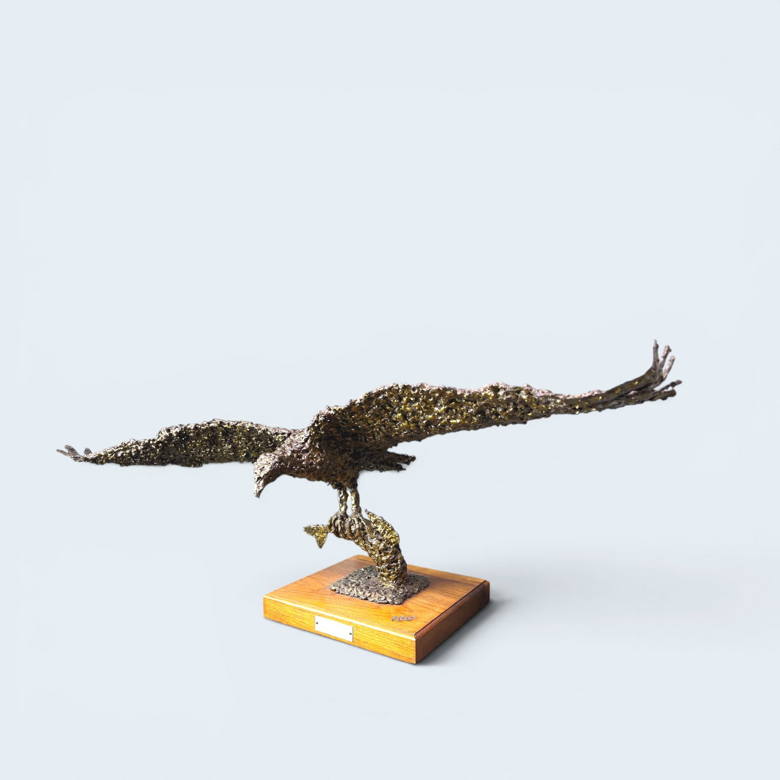 NEAL PETTIGREW, SEA EAGLE - LARGE BRUTALIST BRONZE: Brutalist style bronze figure of a sea eagle with fish in his talons with a wing span of 32". artist Neal Pettigrew from Grady New Mexico. Anitials burned into wood base at top right. figure stands 16