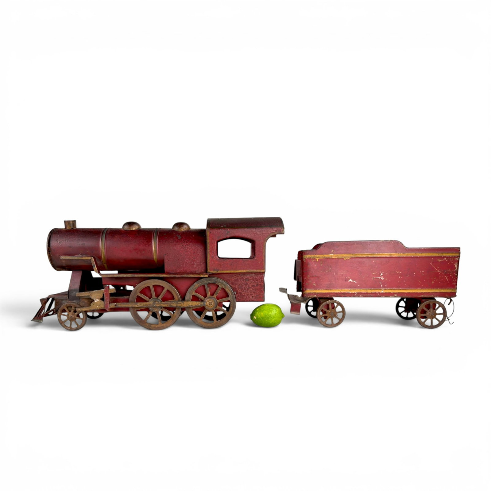 ANTIQUE PRESSED STEEL TOY LOCOMOTIVE and COAL CAR: 8 1/2 x 19 1/2 inches (locomotive) 6 1/2 x 13 inches (coal car)