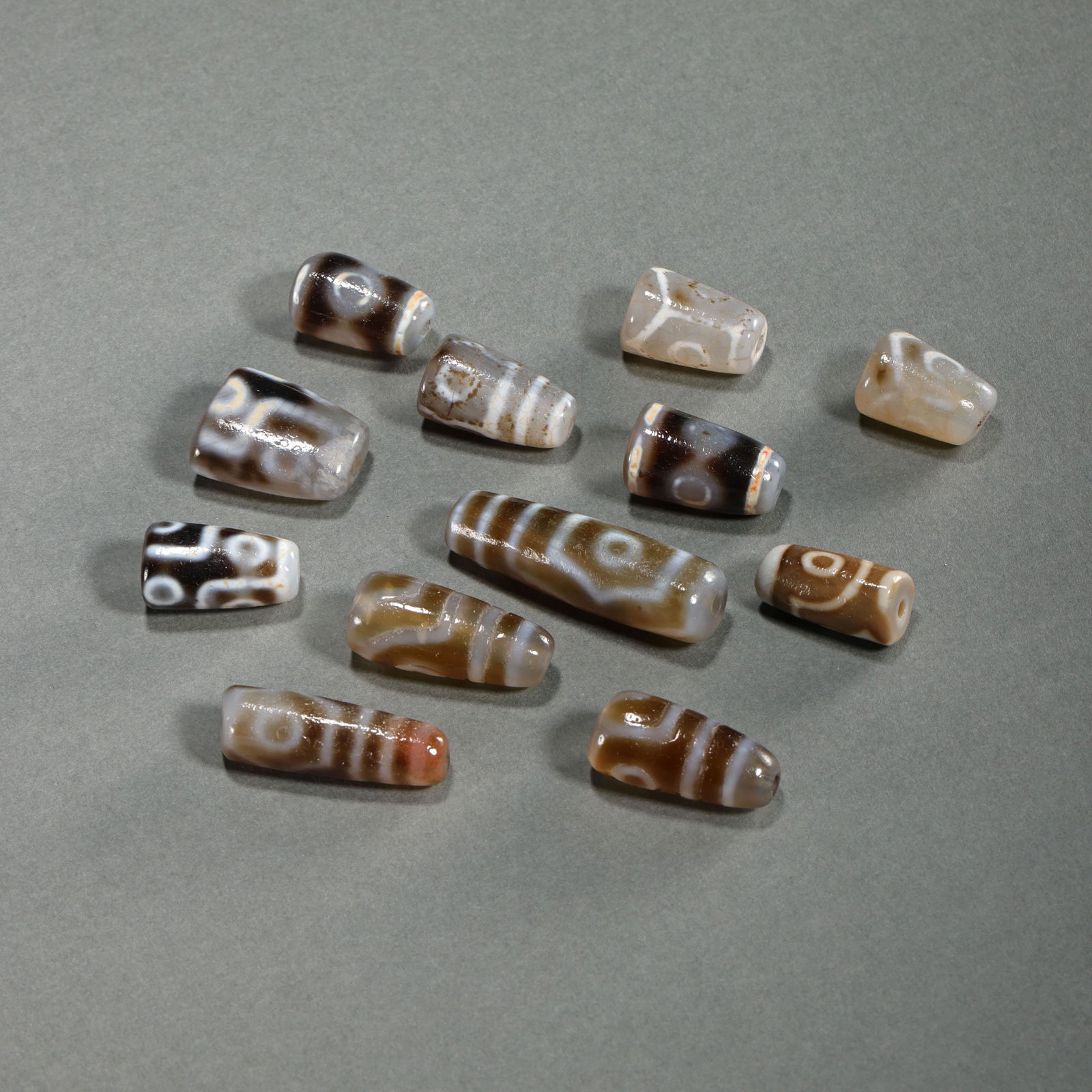 A GROUP OF ANCIENT CHINESE AGATE DZI BEADS (1 of 12)