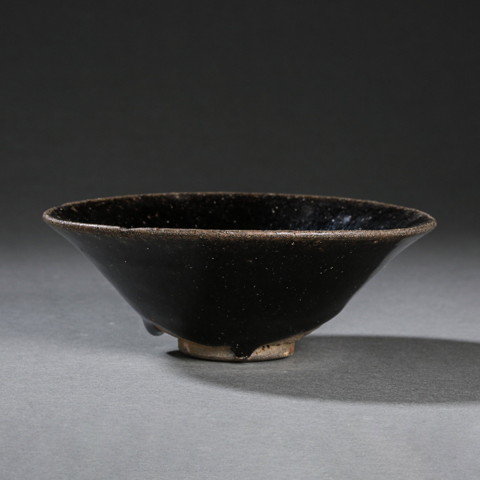 JIAN WARE BLACK GLAZED BUCKET CUP, SOUTHERN SONG DYNASTY, CHINA: JIAN WARE BLACK GLAZED BUCKET CUP, SOUTHERN SONG DYNASTY, CHINA H. 4.5 cm. Diam. 12.7 cm.