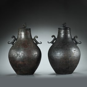 A PAIR OF CHINESE WARRING STATES PERIOD BRONZE COVERED POTS WITH TWO EARS