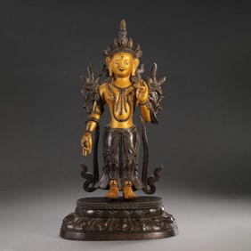 A Chinese gilt bronze statue of a standing Buddha from the Qianlong period of the Qing Dynasty