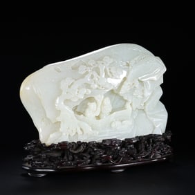 A Chinese Qing Dynasty Hetian white jade carving in the shape of a mountain