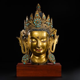 A Chinese Ming Dynasty gilt bronze Buddha head inlaid with gemstones