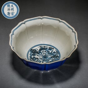 A large bowl with blue and white fish and algae patterns, from the Xuande period of the Ming
