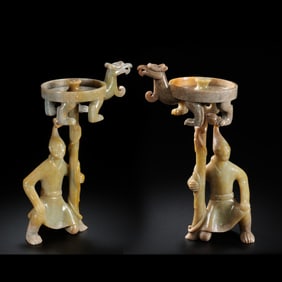 A pair of Chinese Han Dynasty human-shaped jade candlesticks