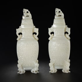 pair of Chinese Qing Dynasty Hetian white jade vases with double-ring ear lids