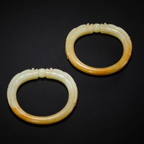 A pair of Chinese Qing Dynasty Hetian jade double dragon bracelets