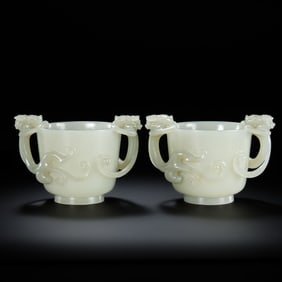 A pair of Hetian white jade double dragon cups from the Qing Dynasty, China