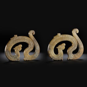 A pair of Chinese Han Dynasty jade dragon pendants