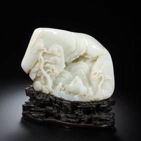A Chinese Qing Dynasty Hetian white jade carving in the shape of a mountain