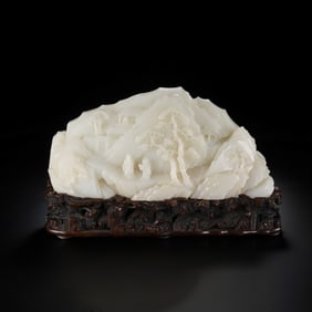 A Chinese Qing Dynasty Hetian white jade carving in the shape of a mountain