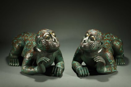 A pair of gold and silver inlaid human-faced beasts from the Warring States Period of China