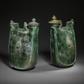 A pair of Chinese Liao Dynasty green-glazed monkey pots