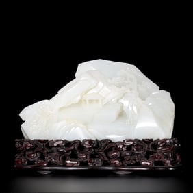 A Chinese Qing Dynasty Hetian white jade carving in the shape of a mountain