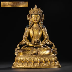A Chinese gilt bronze statue of a seated Buddha from the Qianlong period of the Qing Dynasty