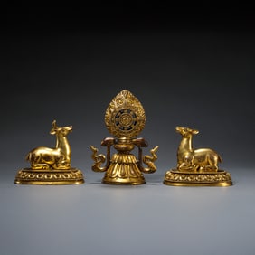 A group of Chinese Qing Dynasty gilt bronze double deer dharma wheel figures