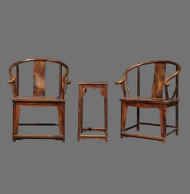 A pair of Chinese Qing dynasty Huanghuali wood armchairs