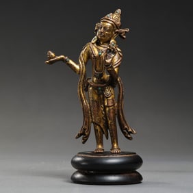 A Chinese Ming Dynasty Gilt Bronze and Gem-Inlaid Standing Buddha