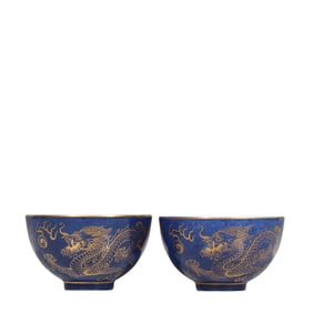 A pair of blue-glazed bowls with gilded dragon designs from the Qing Dynasty, China