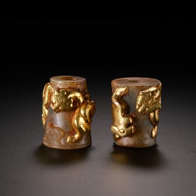 A pair of Chinese Han Dynasty gold-plated jade beads